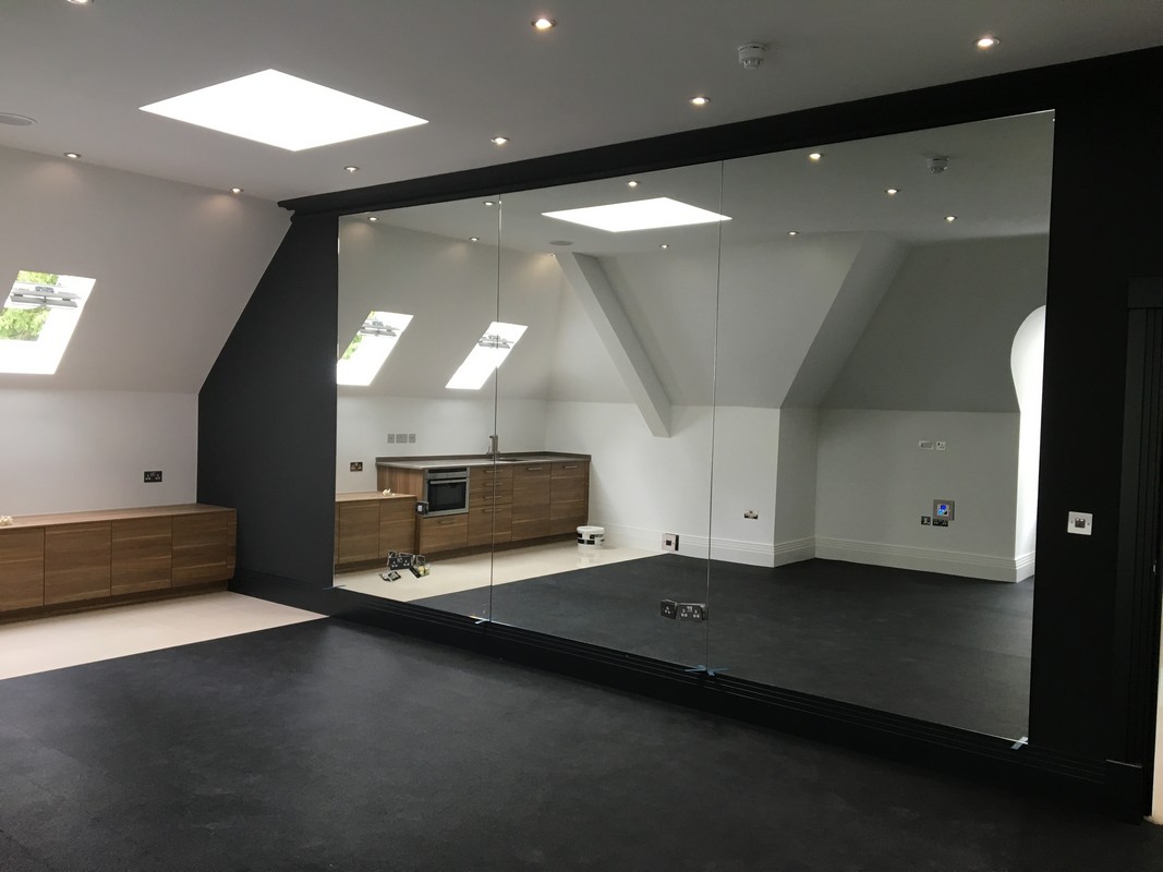 Frameless glass wall dividing loft conversion in South Lambeth