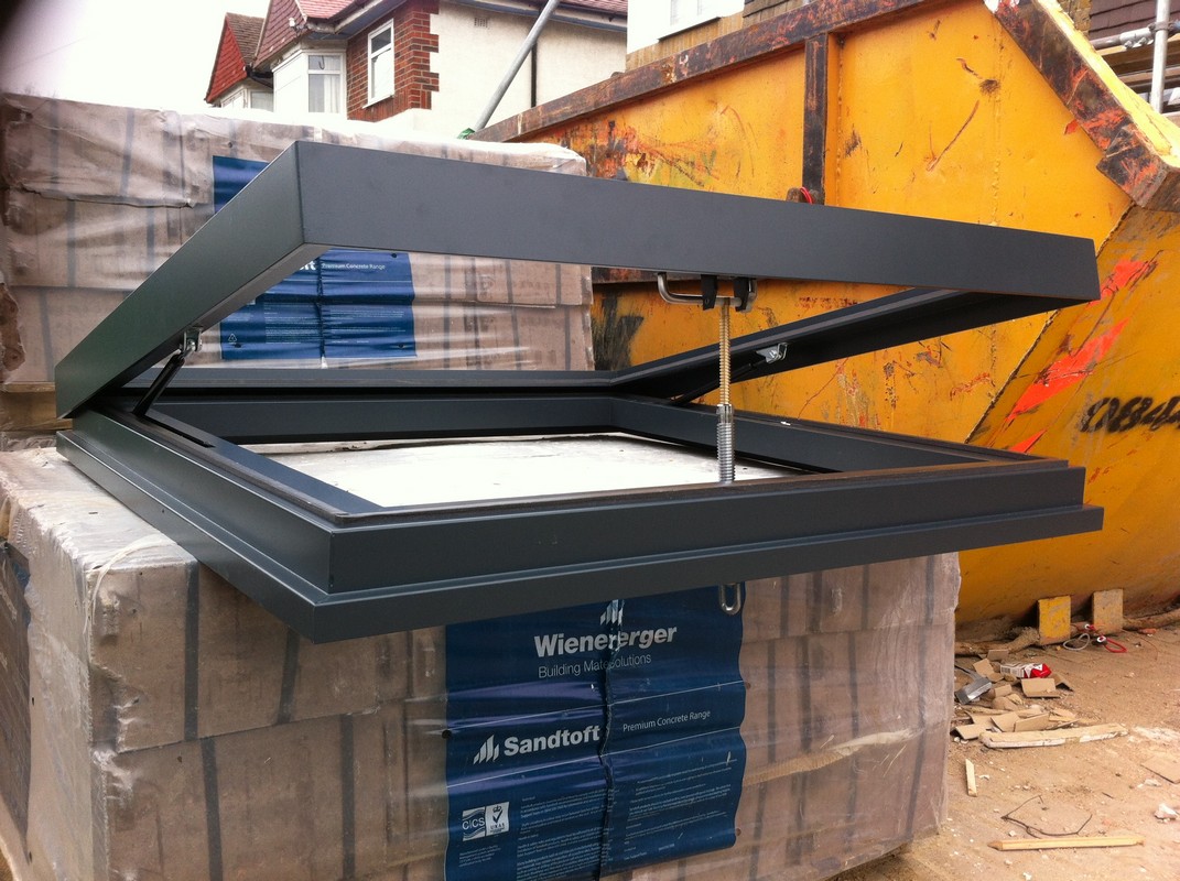 Opening flat roof skylight in anthracite grey installed in South Lambeth