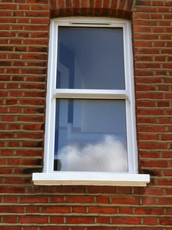 uPVC sash window on Victorian red brick house in South Lambeth